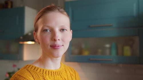 Smiling Woman with Blonde Hair in Kitchen
