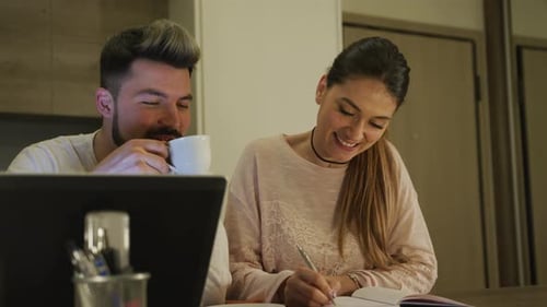 Stylish Couple Working Together Indoors at Table