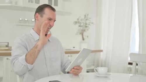 Middle Aged Man Video Calling with Tablet