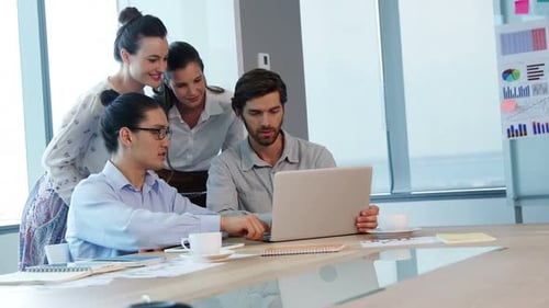 Team Working Together on Laptop in Bright Office