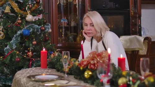 Bored Woman Sits at Christmas Dinner Table