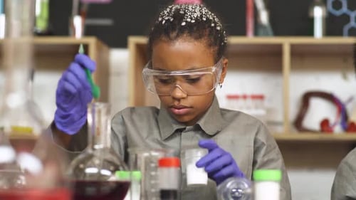 Young Child Conducting Science Experiment in Lab