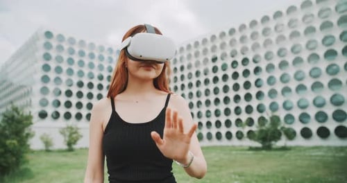 A woman experimenting augmented reality goggles in the city