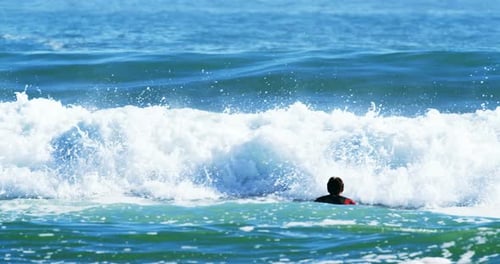 Surfers surfing in sea