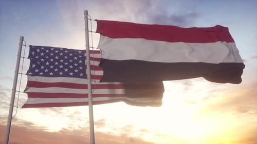 USA and Yemen Flags Waving in Golden Sunset Sky