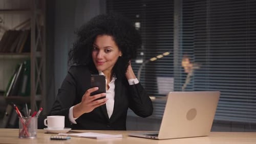 Woman Working at Desk on Laptop at Night