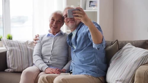 Senior Couple Taking Selfie With Smartphone Indoors