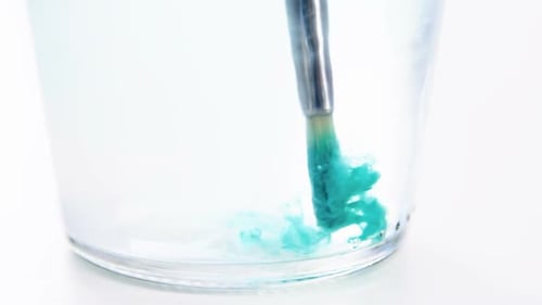 Paintbrush dipping in water