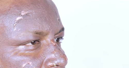 Extreme Close Up Adult Face with Glistening Residue