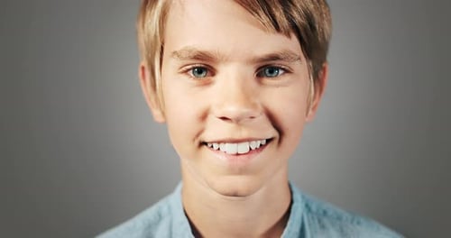 Close-up of Child Smiling on Grey Background