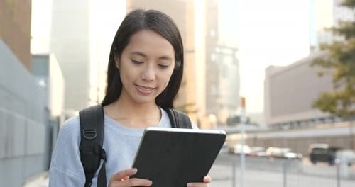 Woman Using Tablet in Urban Setting