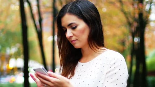 Businesswoman text messaging on mobile phone