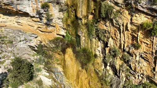 A small waterfall in the mountains aerial view 4 K
