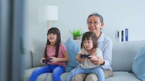 Grandmother and Granddaughters Playing Video Games Together