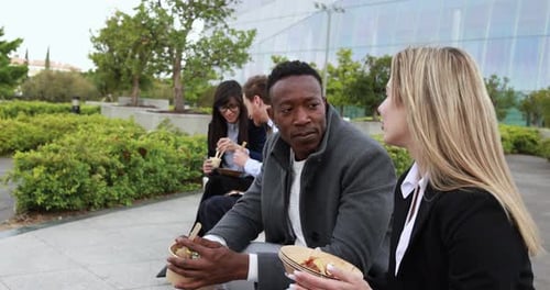 Multiracial business people doing lunch break outdoor from office building