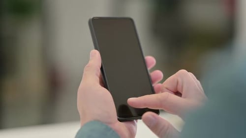 Hands Using Smartphone with Blank Black Screen