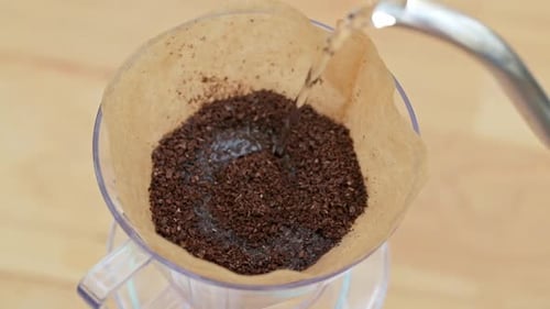 Pouring Water into Coffee Filter for Delicious Drink