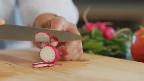 Close up shot of man cutting radish