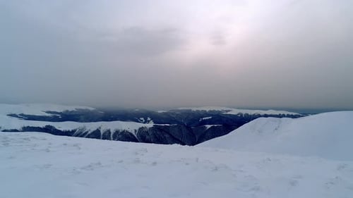 Flight Over the Snowy Mountains Illuminated By the Evening Sun