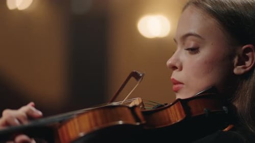 Charming Woman Violinist is Playing Classic Music in Philharmonic Hall Closeup Portrait of Woman