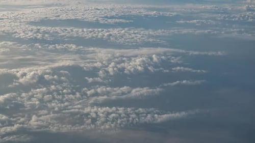 Flight Above Sunset Clouds. View from flying plane.