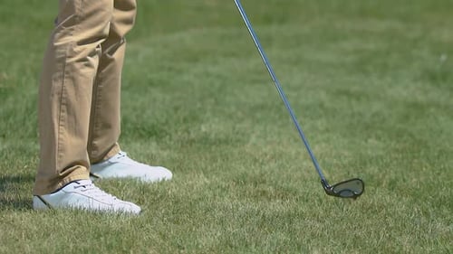 Male Golf Player Making Shot With Iron Club, Practicing in Country Golf Club