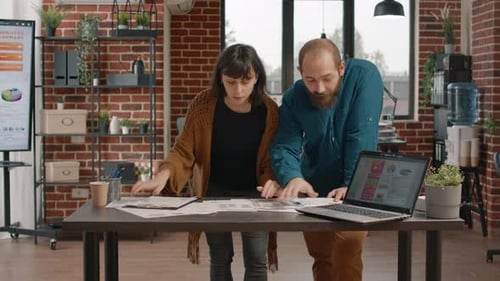 Team Discussing Analytics in Modern Office Setting