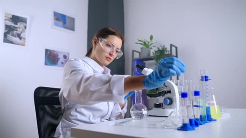 Female Scientist Conducting Experiment in Laboratory