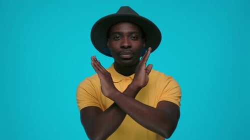 African Man with Crossed Hands Expressing Negative Attitude