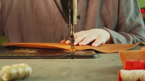 Slow Motion Is the Process of Making and Sewing a Leather Bag. Close-up of a Stitch on a Sewing
