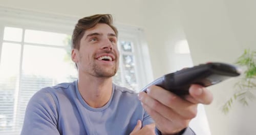 Young Adult Laughing While Watching Television