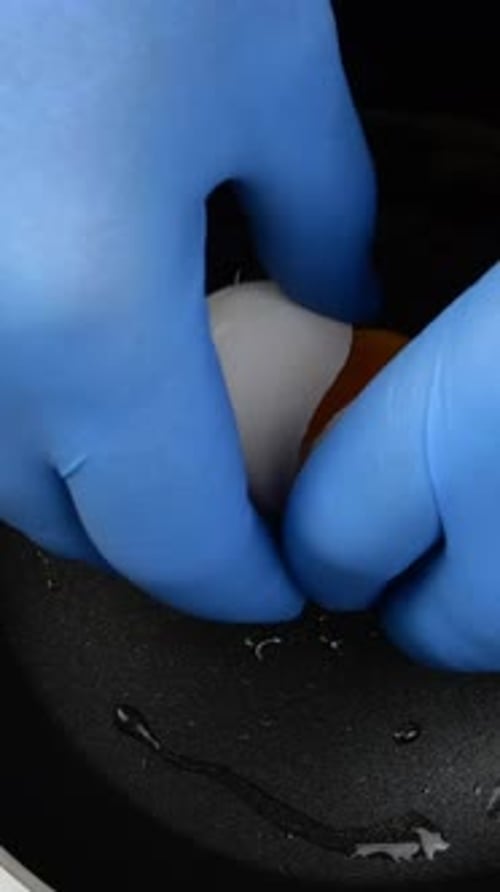 Pouring Chicken Egg Into Hot Pan and Cooking Fried Eggs