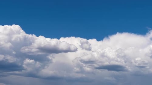 Clouds Drifting across a Bright Blue Sky