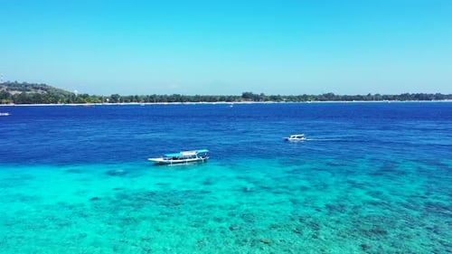 Beautiful above island view of a paradise sunny white sand beach and blue sea background in vibrant