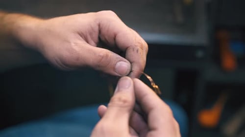 Adult Hands Working With Thin Copper Wire