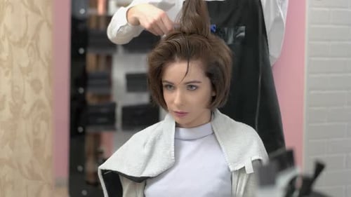 Woman Receiving Haircut and Blow Dry at Salon