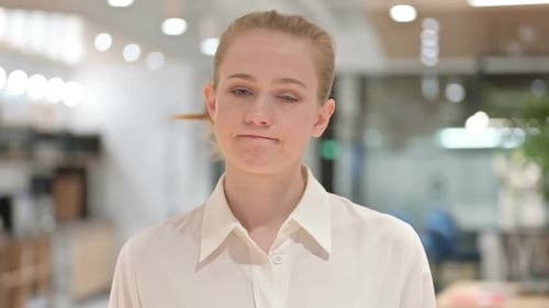 Young Woman Looking at Camera in Office Setting