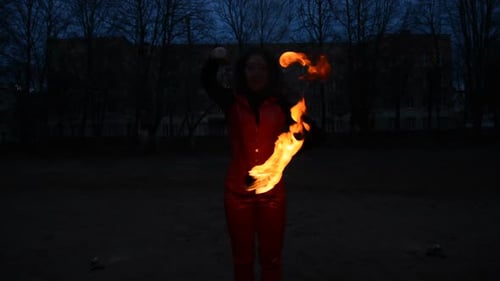 Woman Performs Fire Dance at Night