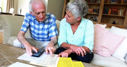 Senior Couple Reviewing Financial Documents at Home