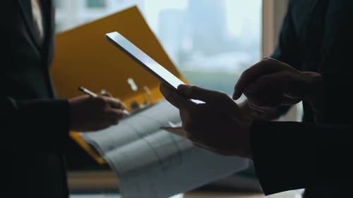 Team Looks at Technical Drawings in Office