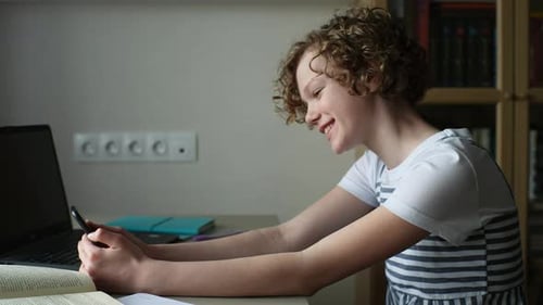 Teenager Using Smartphone at Desk Indoors