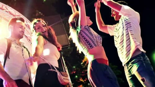 Energetic Young Adults Dancing at an Outdoor Night Event