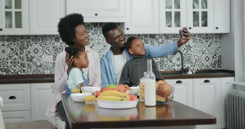 Happy Family Taking Selfie in Modern Kitchen