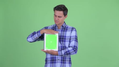 Young Adult Presents a Digital Tablet on Greenscreen