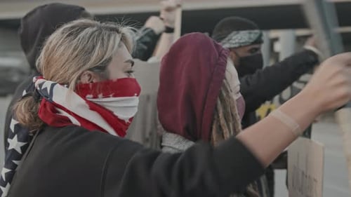 People Raising Arms at Protest Rally