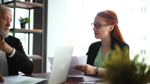 Attractive Young Businesswoman Telling About Work Done and Gives Paper Report To Boss