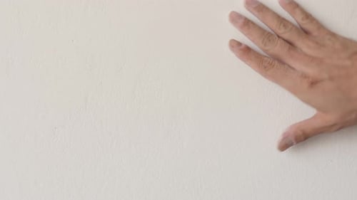 Checking wall surface with hand before painting 4K footage