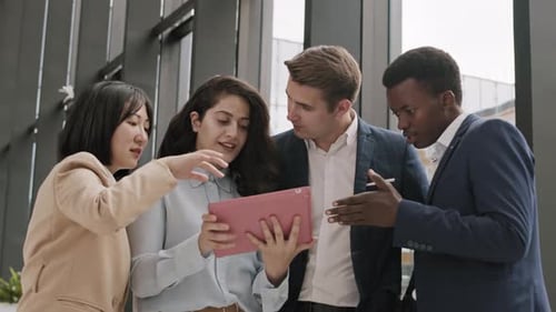 Group of Colleagues Using Tablet in Office