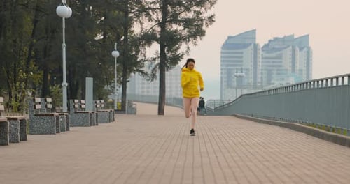 Young Woman Running In The Park