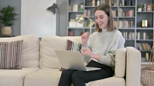 Woman Using Laptop for Video Call at Home